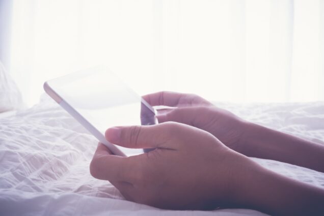 Close up of hands holding a tablet