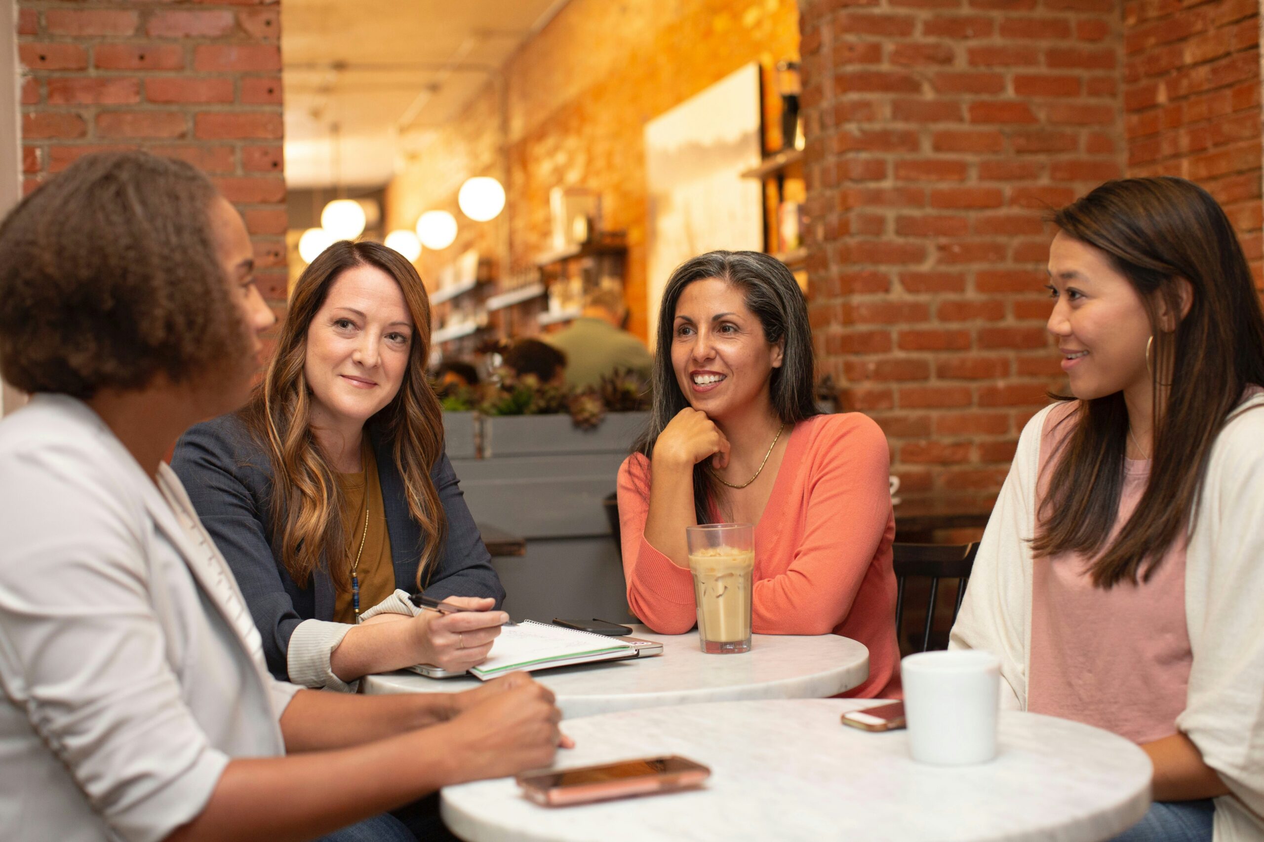 picture of women sitting around a table discussing
