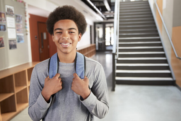 Boy in school wearing a backpack