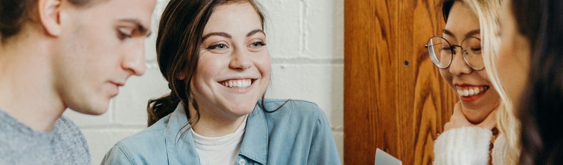 Four young people in a cafe chatting