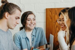 Four young people in a cafe chatting