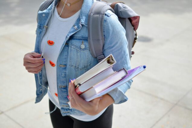 Female holding text books