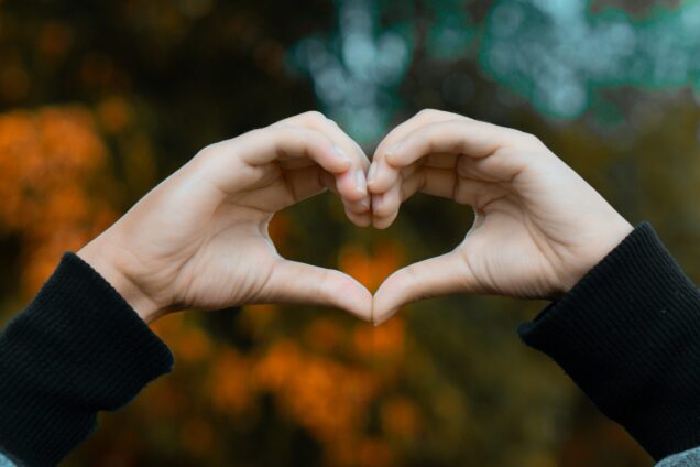 Someone creating a heart with their hands
