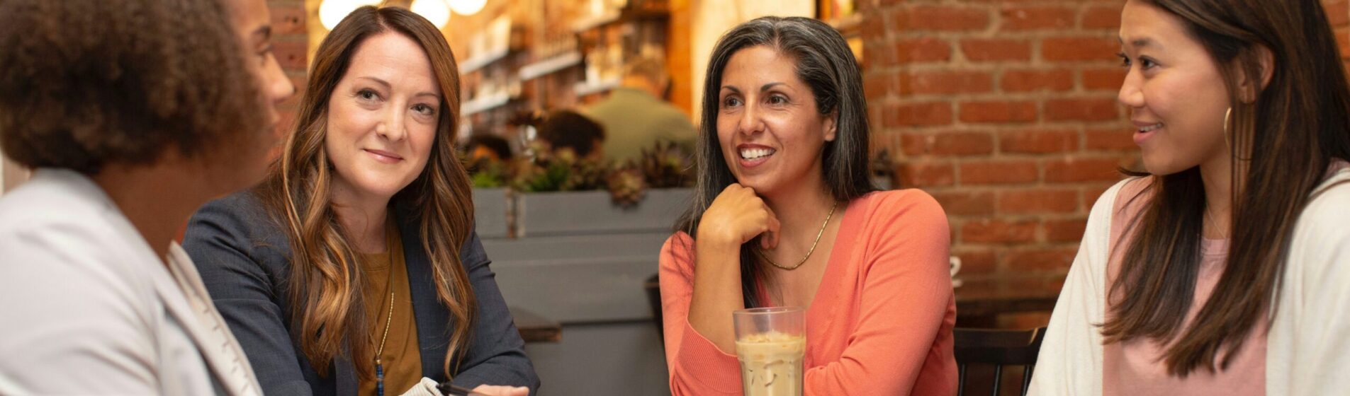 picture of women sitting around a table discussing